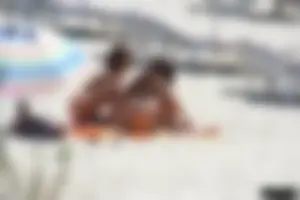 Topless milf and her topless daughter on the beach