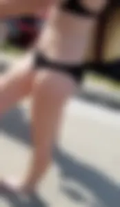 Cute brunette looking sexy in black bikini with friends