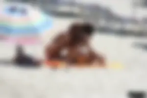 Topless milf and her topless daughter on the beach