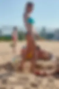 Sexy blonde milf on the beach in blue thong bikini and showing nice camel toe