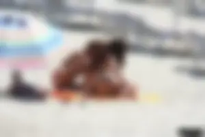 Topless milf and her topless daughter on the beach