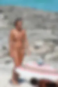 Older lady on a nude beach showing her body