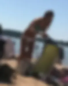 Swedish beach blonde girl in white and green bikini