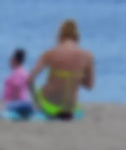 Sexy ass blonde milf on the beach in a thong with cameltoe and bending over