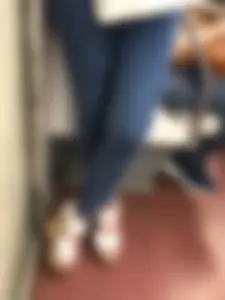 Candid girl wearing tight blue jeans and sandals on high platforms