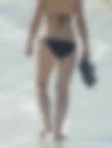 Lady on the beach in black bikini with nice ass