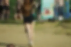 Girl with Chubby Legs in Black Shorts Walking on the Beach Photos