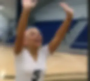 Bunch of cute college girls in bright pink shorts playing volleyball