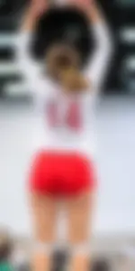 Female Volleyball Player in Red Spandex Shorts Jumping