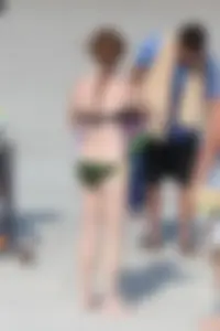 Pale redhead teen in bikini on the beach