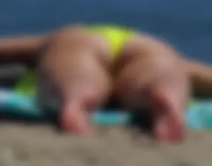 Sexy ass blonde milf on the beach in a thong with cameltoe and bending over