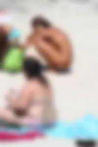 Older lady on a nude beach showing her body
