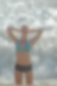Blonde lady on the beach in bikini top and spandex shorts with a nice gap