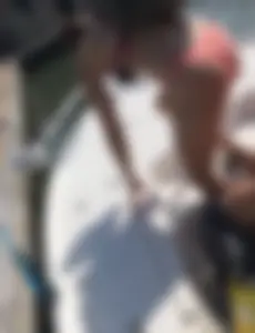 Sexy chick in a swimsuit wearing a backpack bending over while getting off a boat creepshot