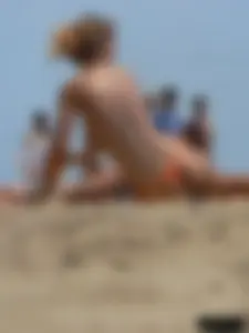 Two topless friends on the beach with nice boobs
