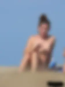 Sexy babe with a nice body topless and in a thong on the beach