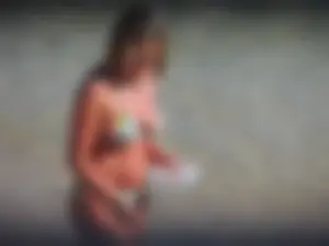 Blonde milf on the beach in her bikini