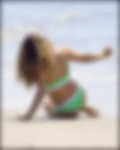 Super hot beach babe with a perfect body in a green thong bikini