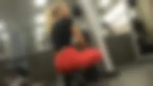 Very hot and sexy blonde at the gym working out in red leggings