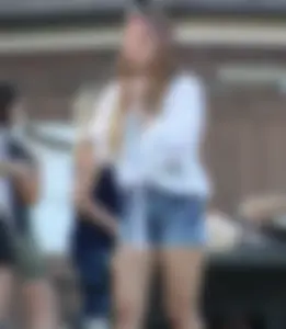 Hippie type dressed girl in denim shorts with a nice ass