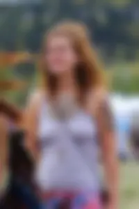 Cute hippie chick in tank top with no bra showing pokies