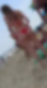 Sexy girl at the beach in a red thong bikini with nice tits and ass
