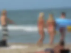 Sexy mom and daughter in red thongs at the beach