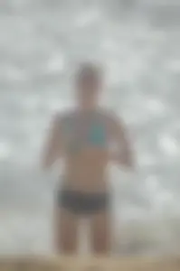 Blonde lady on the beach in bikini top and spandex shorts with a nice gap
