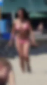 Sexy brunette on the beach in a bikini with great tits