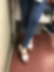 Candid girl wearing tight blue jeans and sandals on high platforms