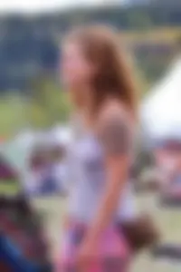 Cute hippie chick in tank top with no bra showing pokies