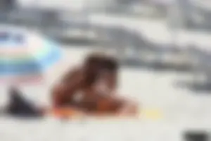 Topless milf and her topless daughter on the beach