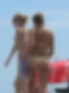 Sexy blonde on the beach in a yellow thong bikini