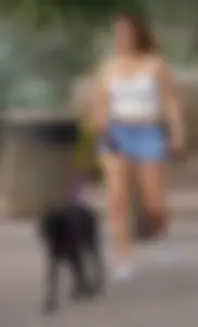 Sexy dog walker in shorts and tank top with friend in blue jeans