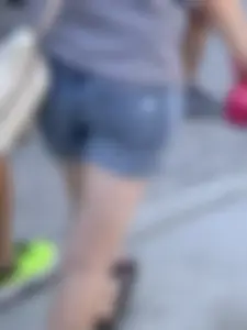 Bunch of girls in various outfits at a Cardinals baseball game