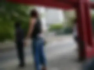 Red haired lady with a nice ass in tight jeans waiting for the bus