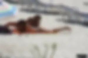 Topless milf and her topless daughter on the beach