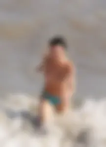 Cute brunette lady topless at the beach with awesome tits