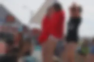 A group of teens in bikinis on the beach