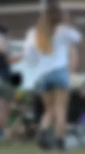 Hippie type dressed girl in denim shorts with a nice ass