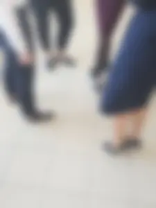 Legs of a Group of College Girls Standing in a Corridor