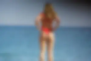 Hot blonde with a slammin body in red thong bikini on the beach