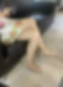 Crossed legs of a girl wearing a short dress and pantyhose creepshot closeup