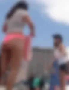 Pink and patterned bikini girls' asses laying on the beach