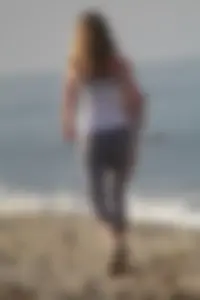 Skinny blonde on the beach in tight grey leggings