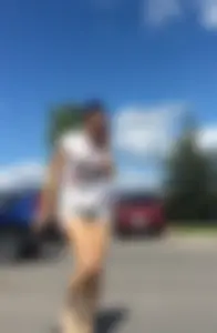 Sexy babe in short jeans shorts on the phone