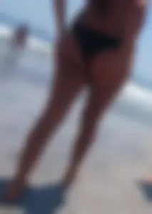 Thick brunette beach babe booty in a little black bikini