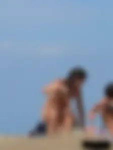 Sexy babe with a nice body topless and in a thong on the beach