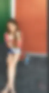 Skinny Girl With Thin Legs Sitting on the Street in Sandals With Crossed Legs