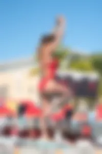 Hot brunette teen diver in red swimsuit with pokies